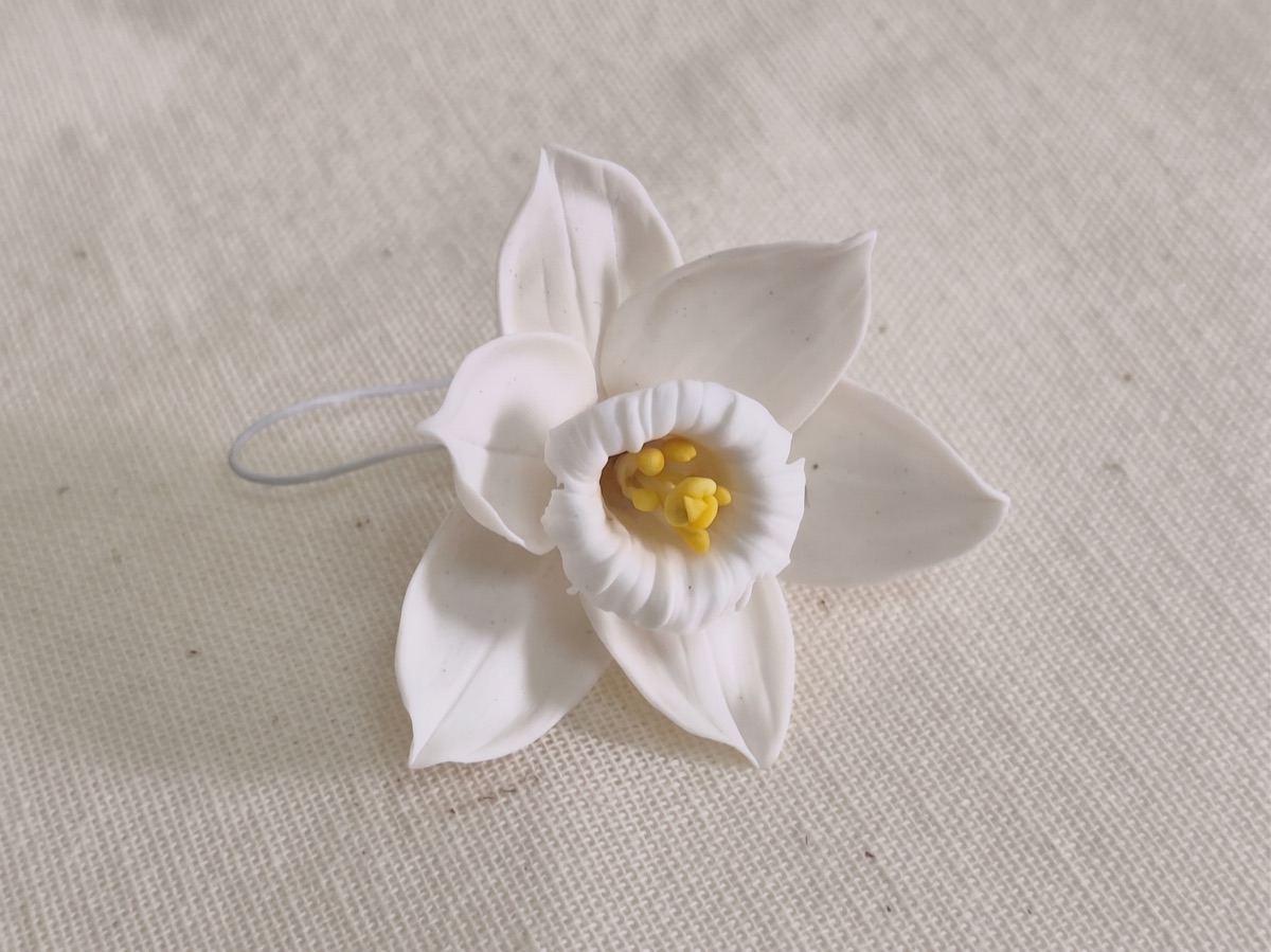 Hand-sculpted ivory white cold porcelain daffodil with a yellow centre