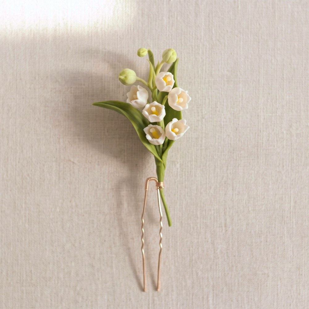 Ivory White cold porcelain lily of the valley spray with green leaves on a U-shape hair pin